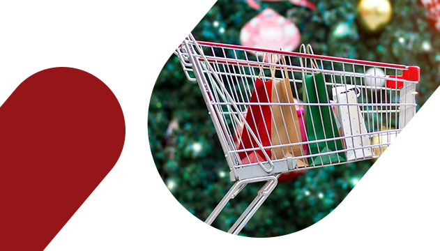 O que vender no Natal: carrinho com sacolas na frente de uma árvore de Natal